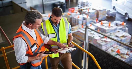 industrial workers reviewing a work document